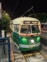 View of cars 1055 and 1061 lined up at the stop on Jones Street